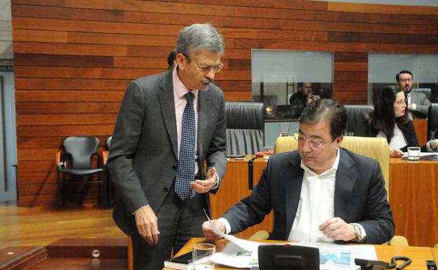 El consejero de Economía, Navarro, junto a Fernández Vara en el pleno de ayer en la Asamblea. /Brígido