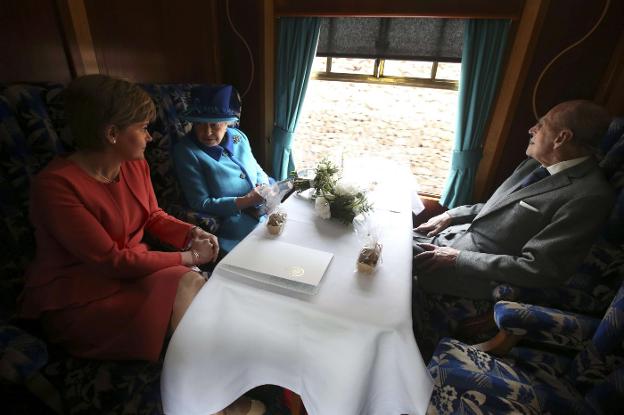 La reina Isabel, con su marido el duque de Edimburgo y la primera ministra escocesa, Nichola Sturgeon, el pasado martes en un tren. :: reuters/