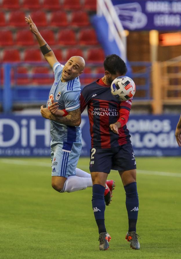 Gorka Santamaría salta con el azulgrana Saúl González. / J. M. ROMERO