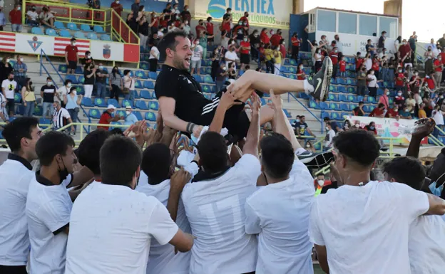 Miguel Espejo es manteado por los jugadores del Badajoz B tras lograr el ascenso en Don Benito. /ESTRELLA DOMEQUE