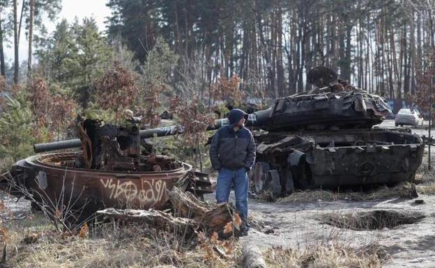 Un hombre observa blindados rusos destruidos a las afueras de Kiev/EFE
